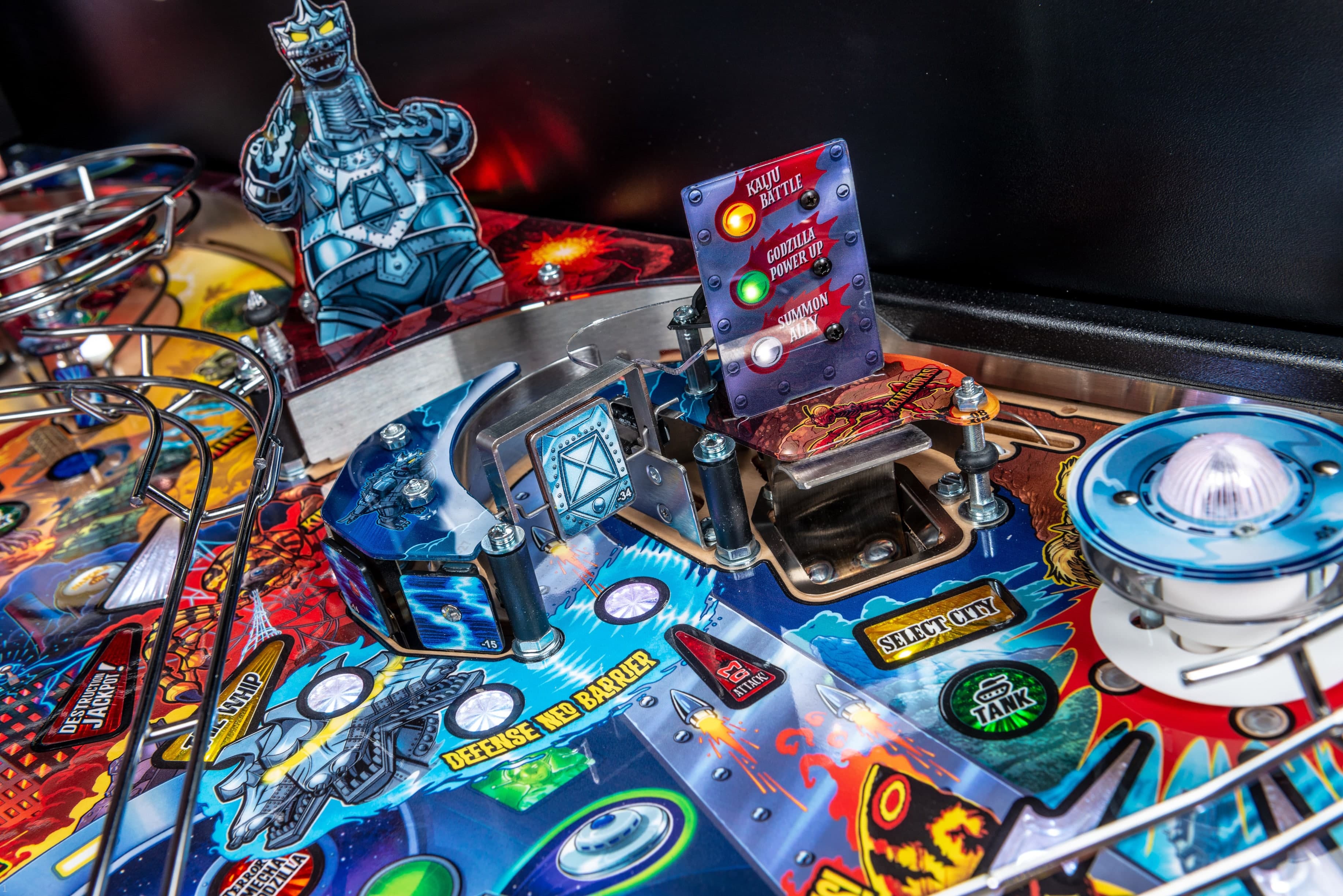 Godzilla-themed pinball machine with colorful buttons and robot characters