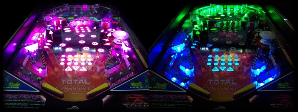 Colorful pinball machine playfield with vibrant pink and green neon lights