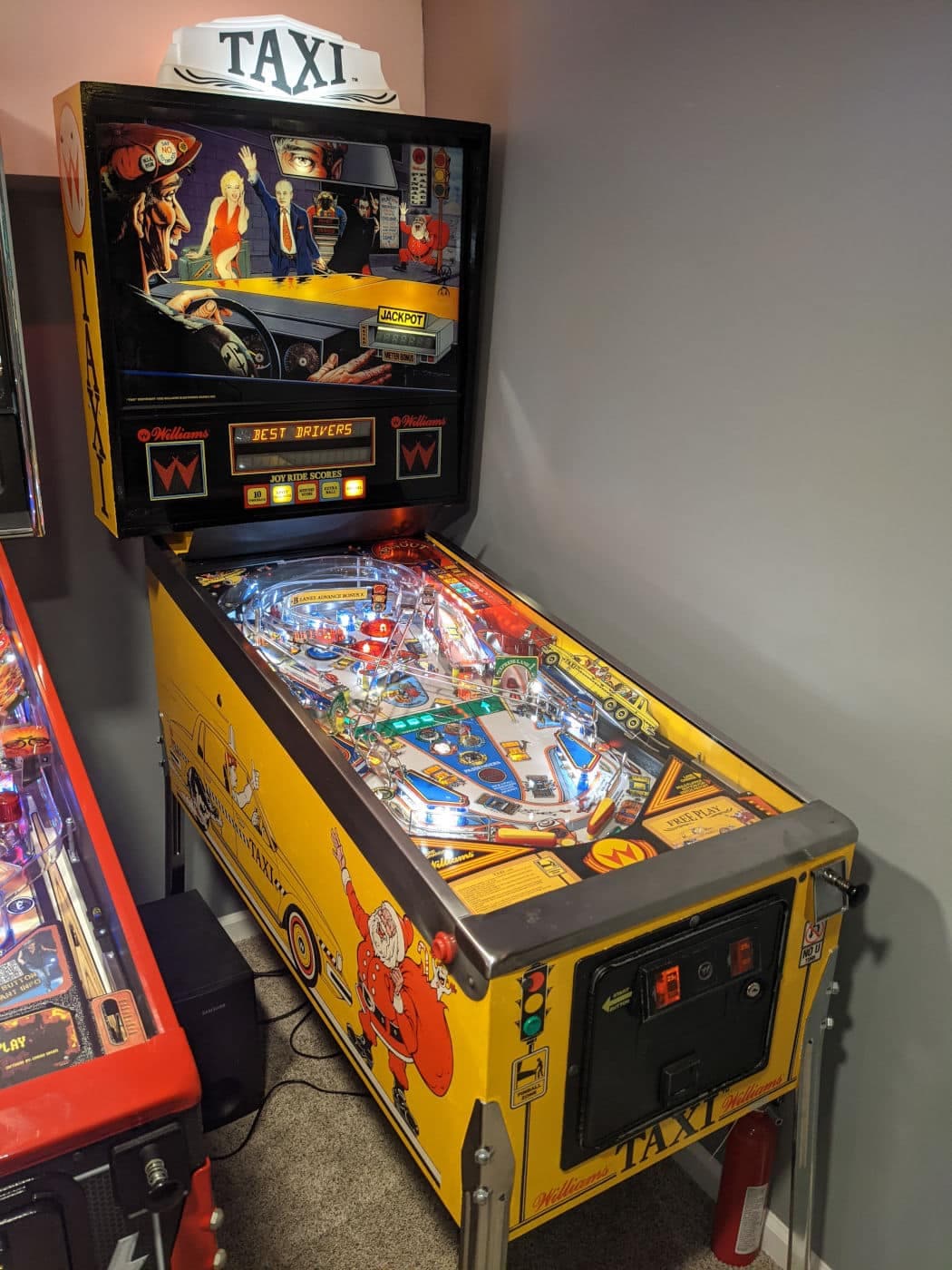 Vintage Taxi pinball machine with colorful artwork and illuminated playfield