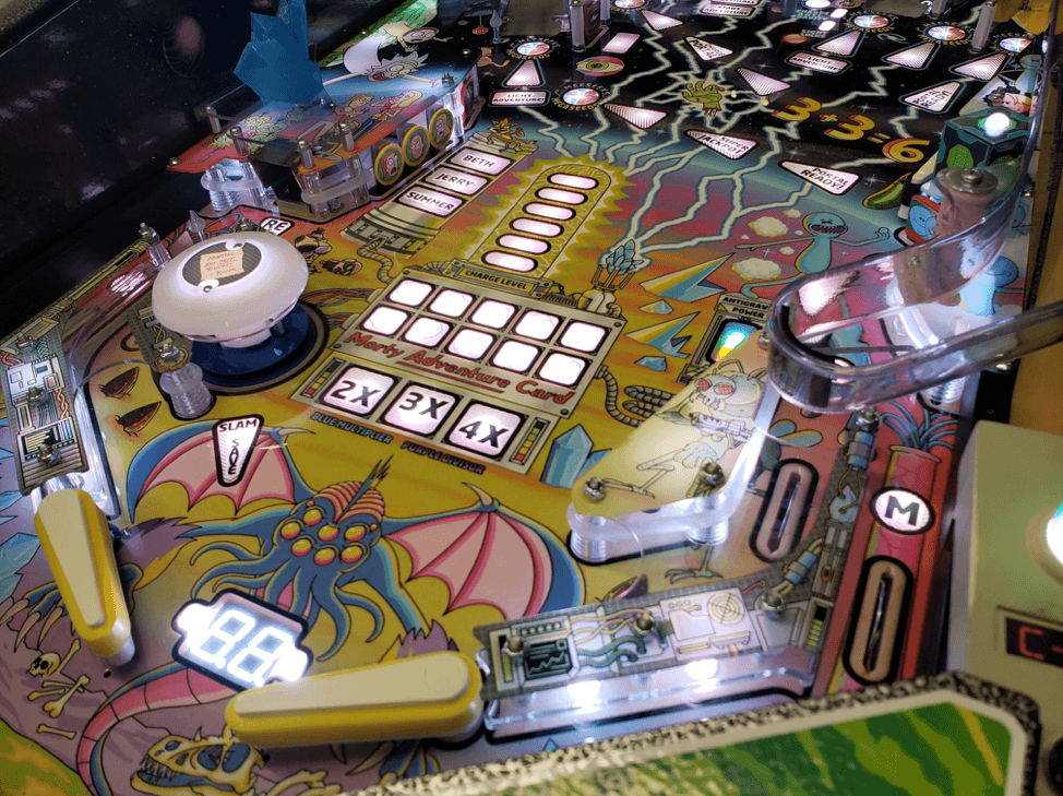 Colorful pinball machine with fantastical creature and electronic scoring display