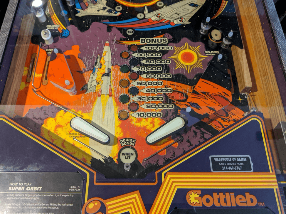 Vintage space-themed pinball machine with rockets and scoring display