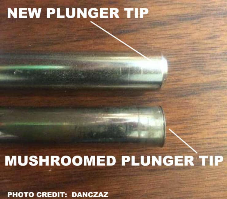 Two metal plunger tips showing new and mushroomed conditions side by side