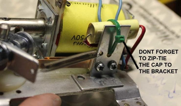 Electronic assembly with yellow capacitor and reminder to zip-tie component