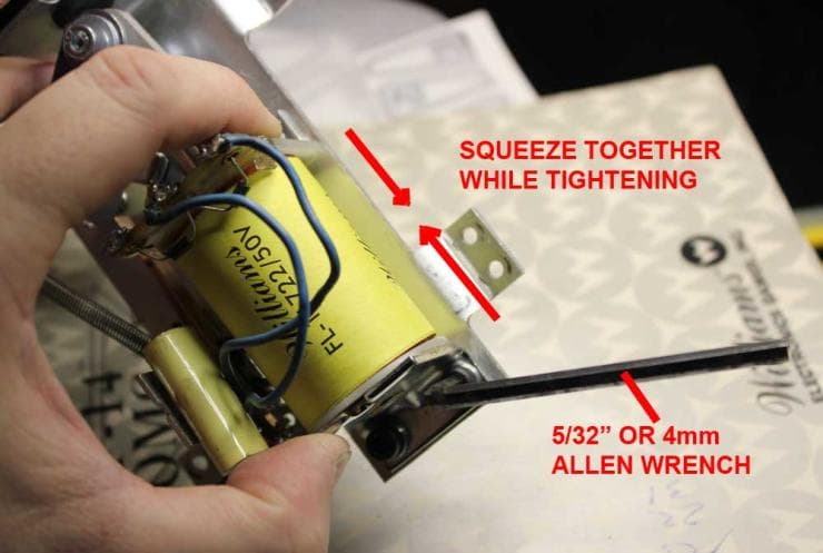 Hand holding yellow coil with instructions for tightening and using Allen wrench