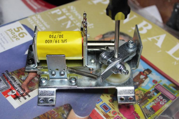 Mechanical device with yellow capacitor and metal components on printed materials