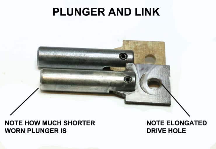 Mechanical components showing worn plunger and elongated drive hole