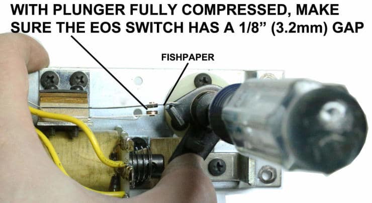 Technical diagram showing electrical switch mechanism with plunger and wiring