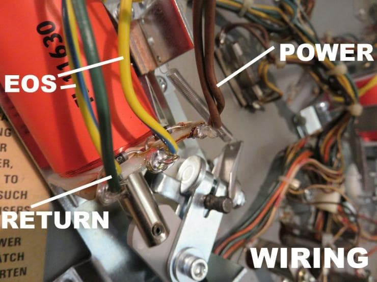 Closeup of electrical wiring with labeled power and return connections