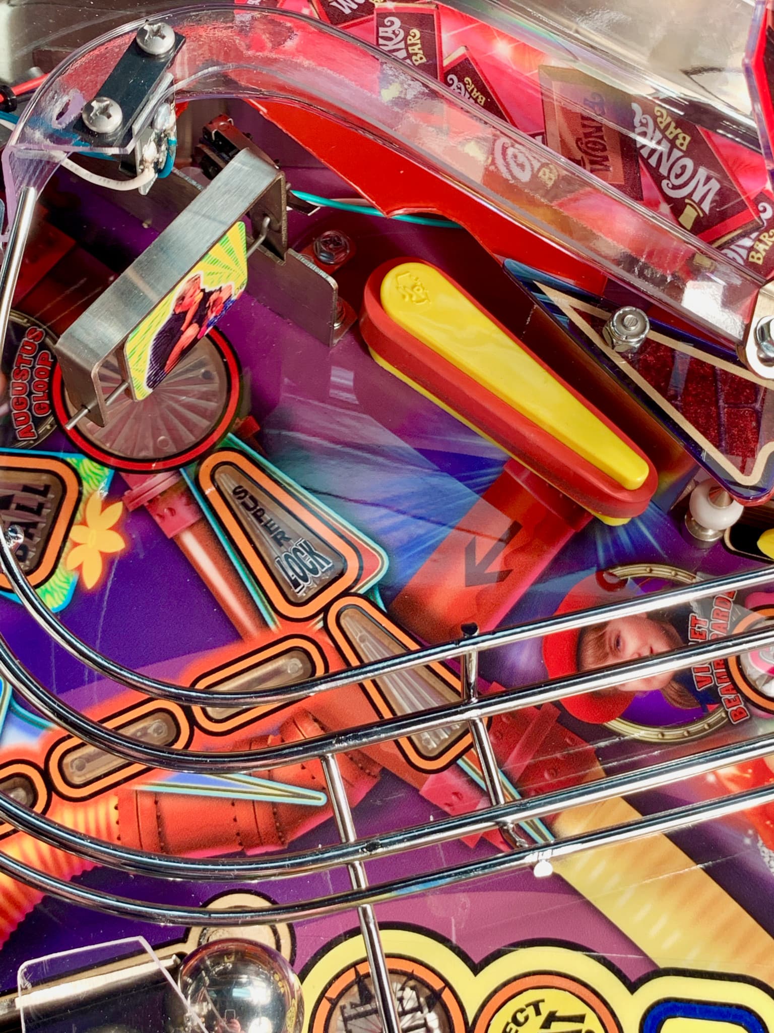 Colorful pinball machine with vibrant red, purple, and yellow components